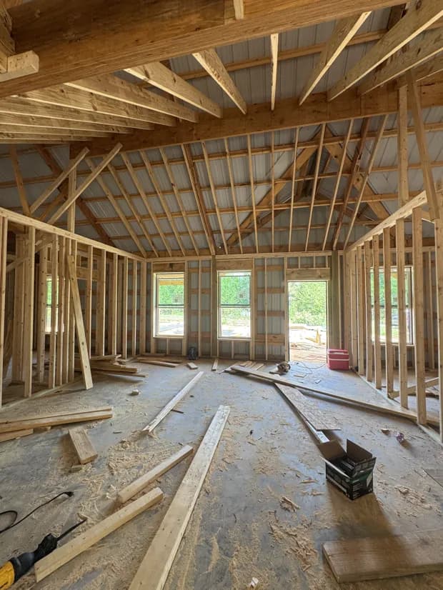 Interior post-frame timber framing in progress